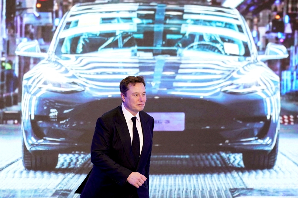 Tesla Inc CEO Elon Musk walks next to a screen showing an image of Tesla Model 3 car during an opening ceremony for Tesla China-made Model Y program in Shanghai, China, on January 7, 2020.  File Photo / Reuters