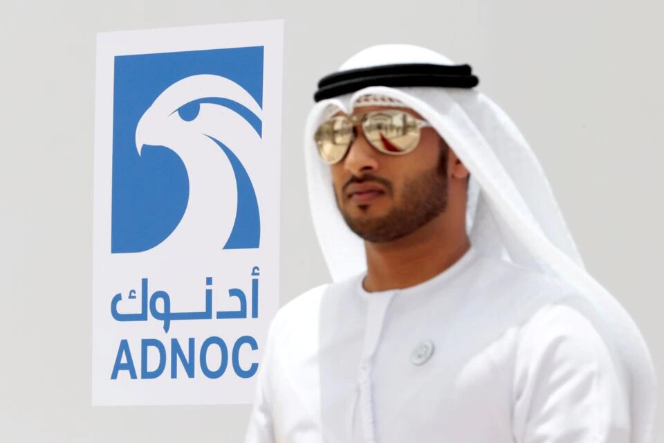 An Emirati man is seen near the logo of ADNOC in Ruwais, United Arab Emirates, on May 14, 2018. Picture taken May 14, 2018. File Photo / Reuters
