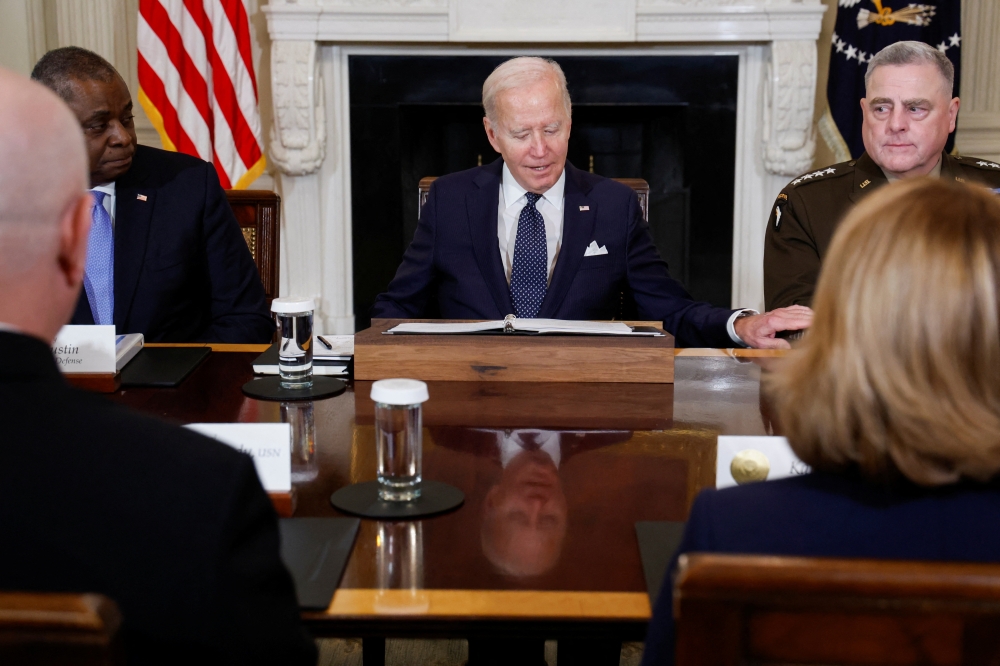 US President Joe Biden, next to US Defence Secretary Lloyd Austin and Chairman of the Joint Chiefs of Staff US Army General Mark Milley, attends a meeting with Defence Department leaders in the State Dining Room at the White House in Washington, US, on October 26, 2022. REUTERS/Jonathan Ernst