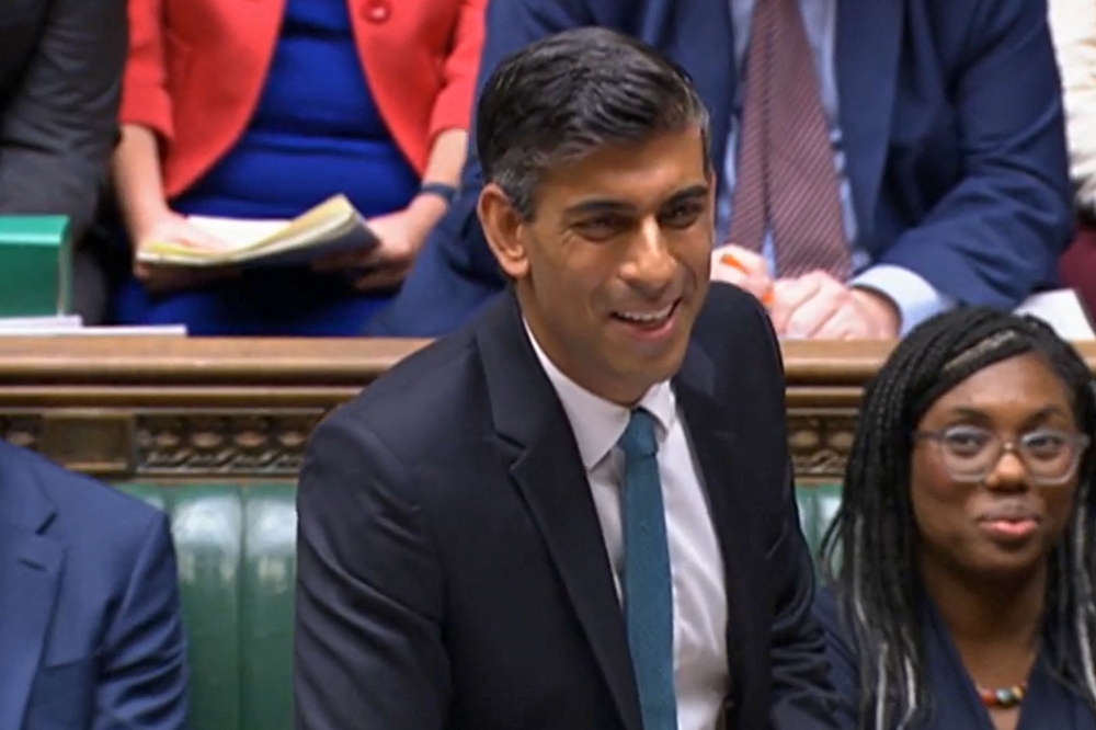 In this video grab taken from footage broadcast by the UK Parliamentary Recording Unit (PRU) via the Parliament TV website on October 26, 2022, Britain's Prime Minister Rishi Sunak speaks during his first Prime Minister's Questions (PMQs) in the House of Commons.(Photo by PRU / AFP)