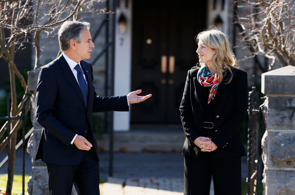 Canada's Foreign Minister Melanie Joly and US Secretary of State Antony Blinken speak outside the Canadian Government Guest House ahead of a working lunch, in Ottawa, Ontario, Canada, on October 27, 2022. (Photo by BLAIR GABLE / POOL / AFP)