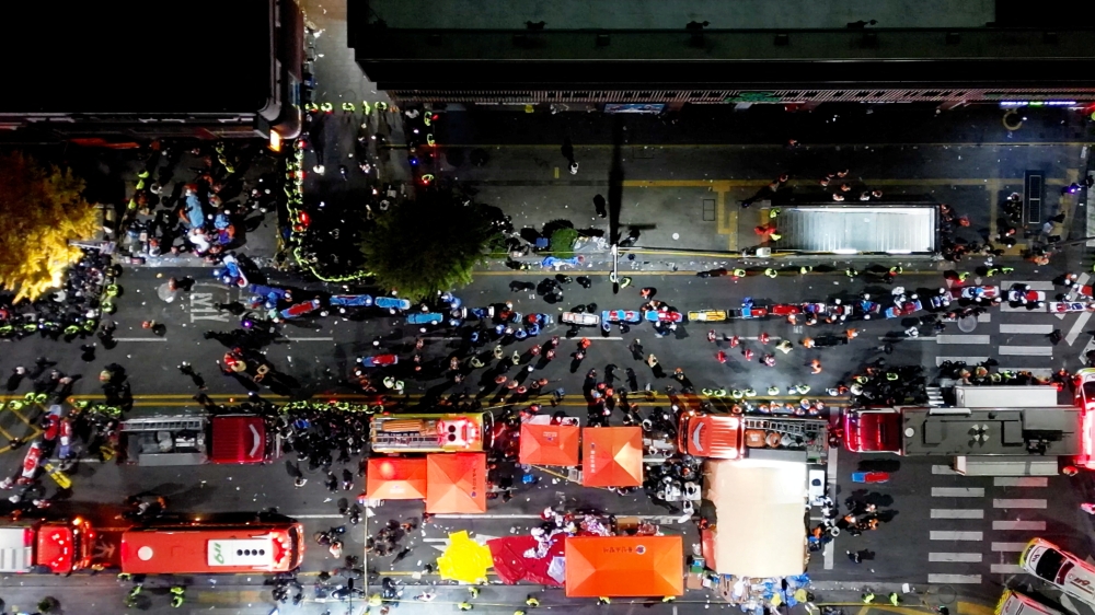 Rescue workers work at the scene where a stampede during Halloween festivities killed and injured many people at the popular Itaewon district in Seoul, South Korea, October 30, 2022. Yonhap via Reuters 