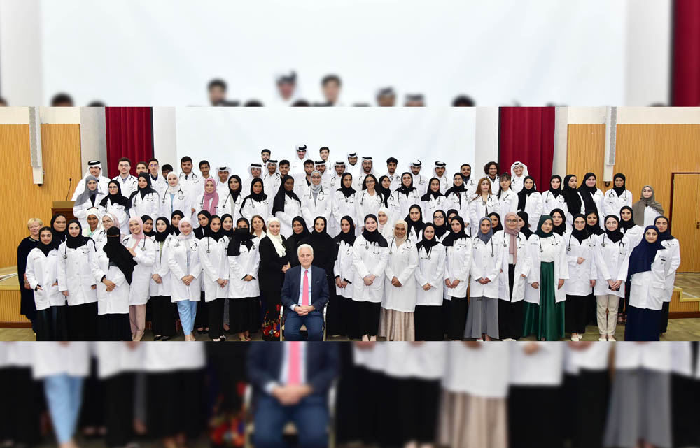 A group photo of students with officials at The White Coat ceremony of the College of Medicine at Qatar University.