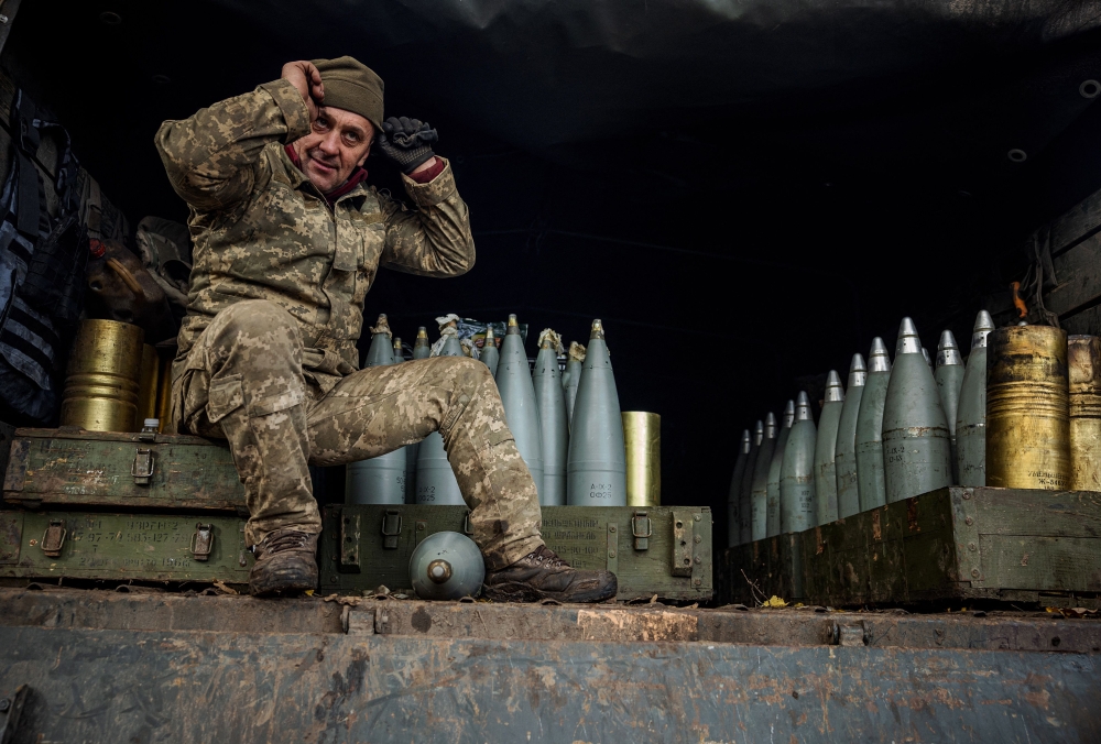 A Ukrainian artilleryman sits in a military truck at a position on the front line near the town of Bakhmut, in eastern Ukraine's Donetsk region, on October 31, 2022, amid the Russian invasion of Ukraine. (Photo by Dimitar DILKOFF / AFP)