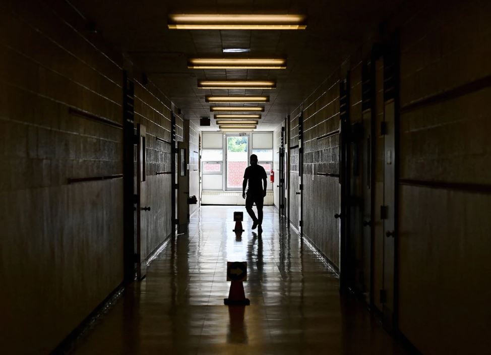 File Photo: A teacher walks the divided hallways at Hunter's Glen Junior Public School, part of the Toronto District School Board, in Scarborough, Ontario, Canada, September 14, 2020. (Nathan Denette/Pool via REUTERS)