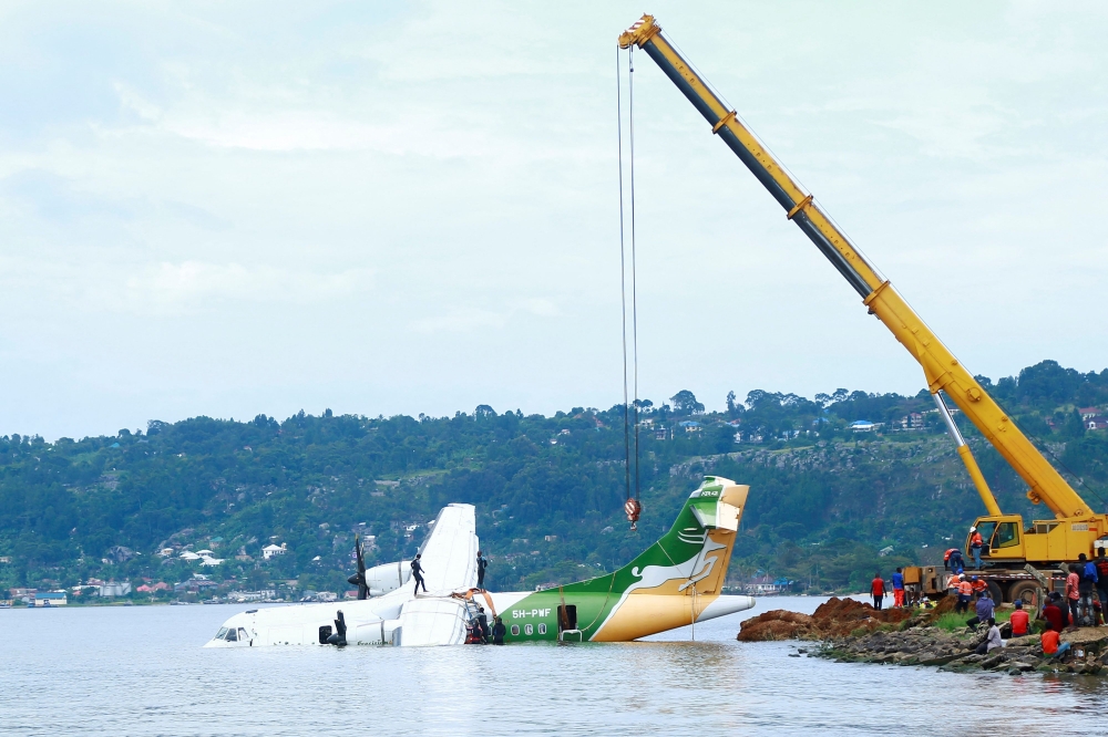 Workers use a crane to pull the crashed Precision Air aircraft out of Lake Victoria in Bukoba, Tanzania, on November 8, 2022. Photo by Sitide Protase / AFP