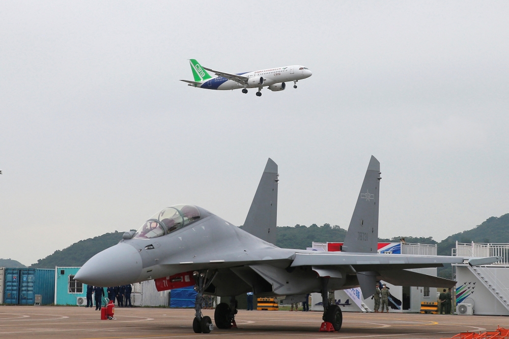 Chinese passenger jet C919 performs near a fighter jet of the Chinese People's Liberation Army (PLA) Air Force, at the China International Aviation and Aerospace Exhibition, or Airshow China, in Zhuhai, Guangdong province, China November 8, 2022. (China Daily via REUTERS) 