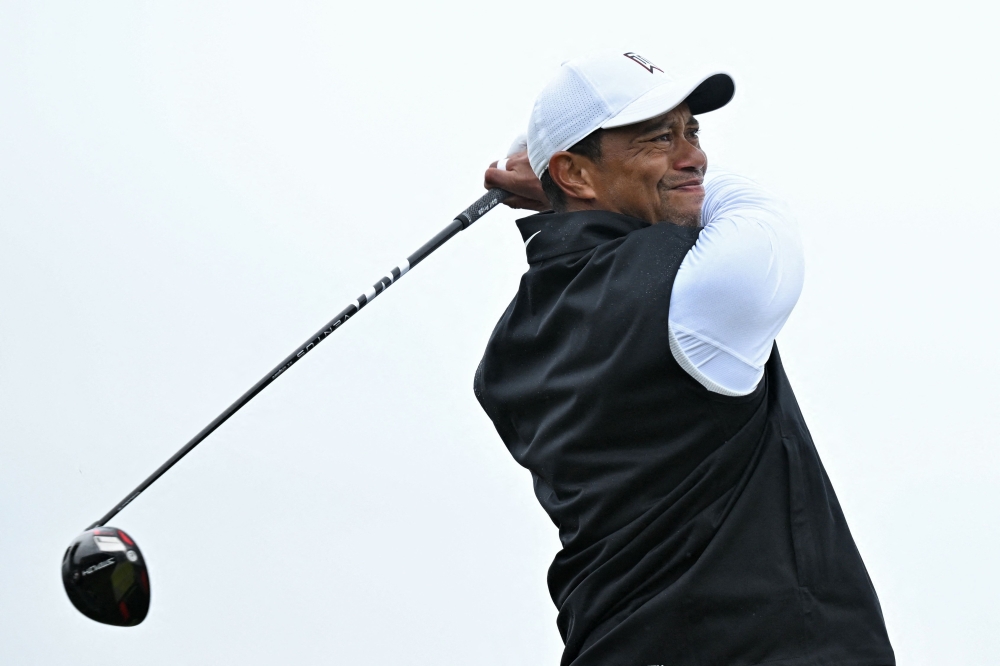 In this file photo taken on July 15, 2022, US golfer Tiger Woods watches his drive from the second tee during his second round on the day two of The 150th British Open Golf Championship on The Old Course at St Andrews in Scotland. (AFP/Glyn Kirk)