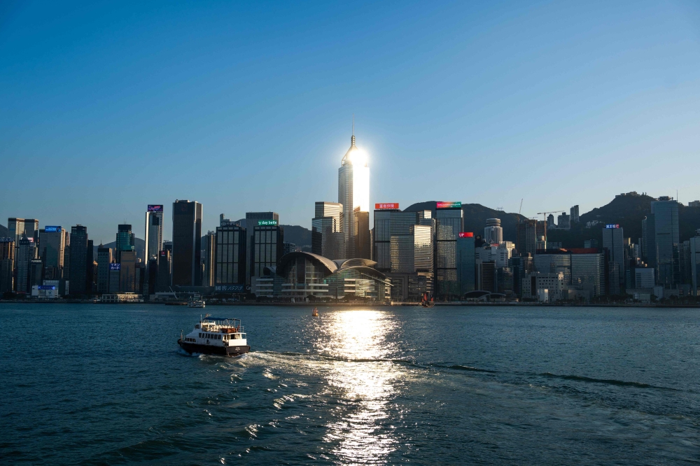 A boat crosses Victoria Harbour in Hong Kong on November 10, 2022. (Photo by Bertha WANG / AFP) 