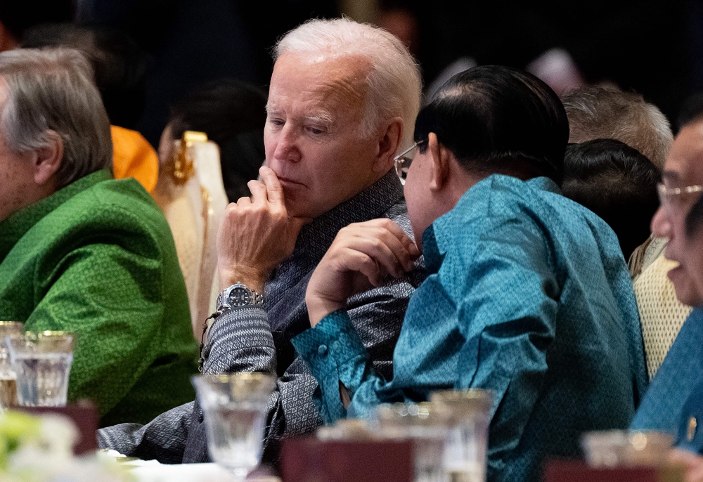 US President Joe Biden (left) and Cambodia's Prime Minister Hun Sen speak as they attend the East Asia Summit Gala dinner in Phnom Penh, on November 12, 2022. (Photo by SAUL LOEB / AFP)