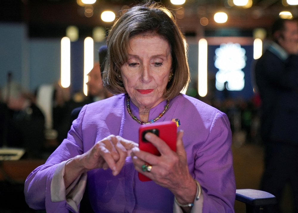 US House Speaker Nancy Pelosi looks at her phone, as she attends the COP27 climate summit, in Sharm el-Sheikh, Egypt, on November 11, 2022. REUTERS/Kevin Lamarque 