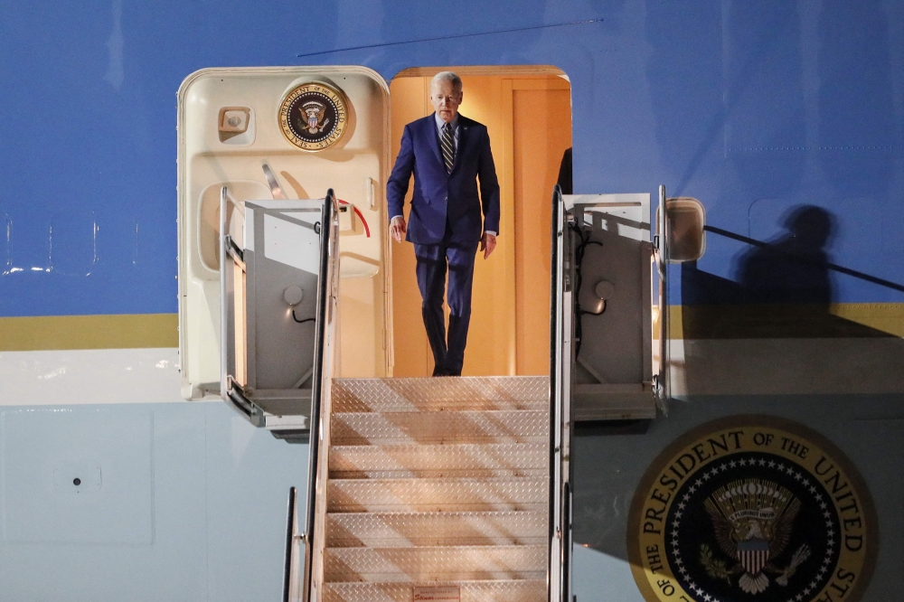 US President Joe Biden disembarks from Air Force One upon arrival at Ngurah Rai International Airport in Denpasar on the Indonesian resort island of Bali, November 13, 2022, as he travels to attend the G20 Summit. (Photo by Made NAGI / POOL / AFP)