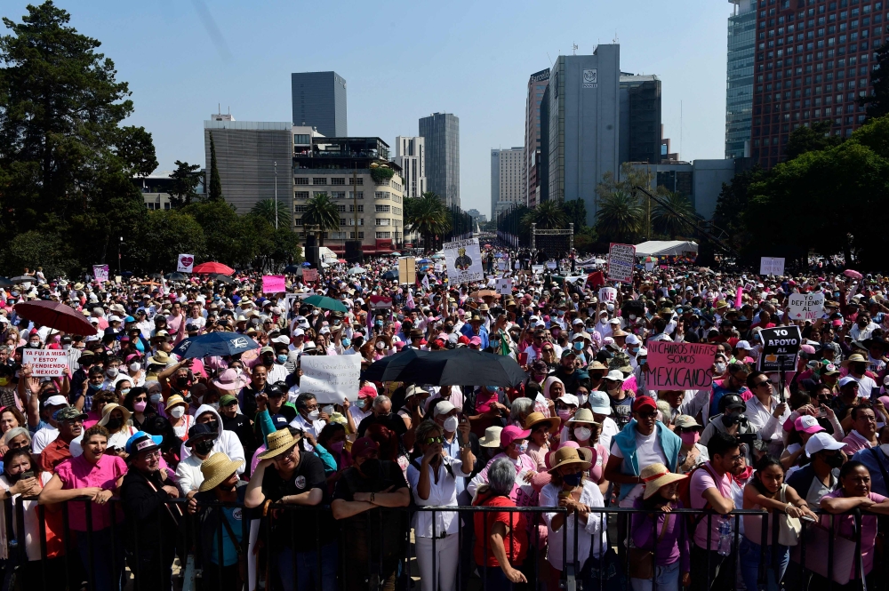 Demonstrators take part in a march against possible government measures to restructure the National Electoral Institute (INE), in mexico City on November 13, 2022. (AFP/ Claudio Cruz)

