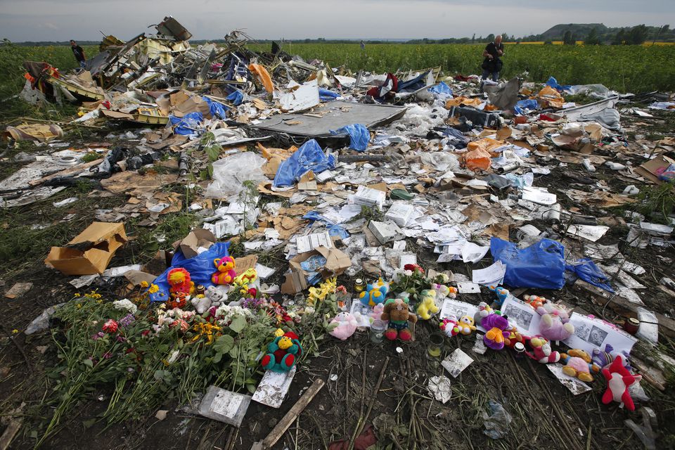 Flowers and mementos left by local residents at the crash site of the Malaysia Airlines Flight MH17 are seen near the settlement of Rozspyne in the Donetsk region, in this July 19, 2014 file photo. (REUTERS/Maxim Zmeyev)