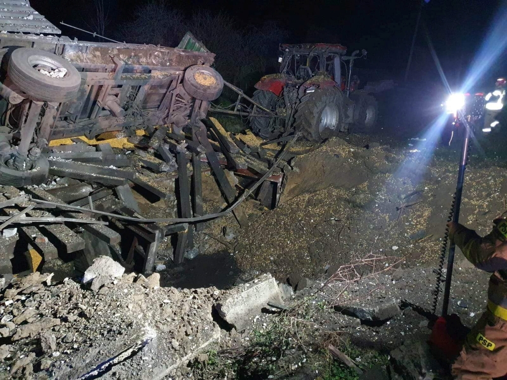 A damaged vehicle lies next to a crater formed at the site of an explosion in Przewodow, a village in eastern Poland near the border with Ukraine, in this photograph obtained by Reuters on November 16, 2022. 