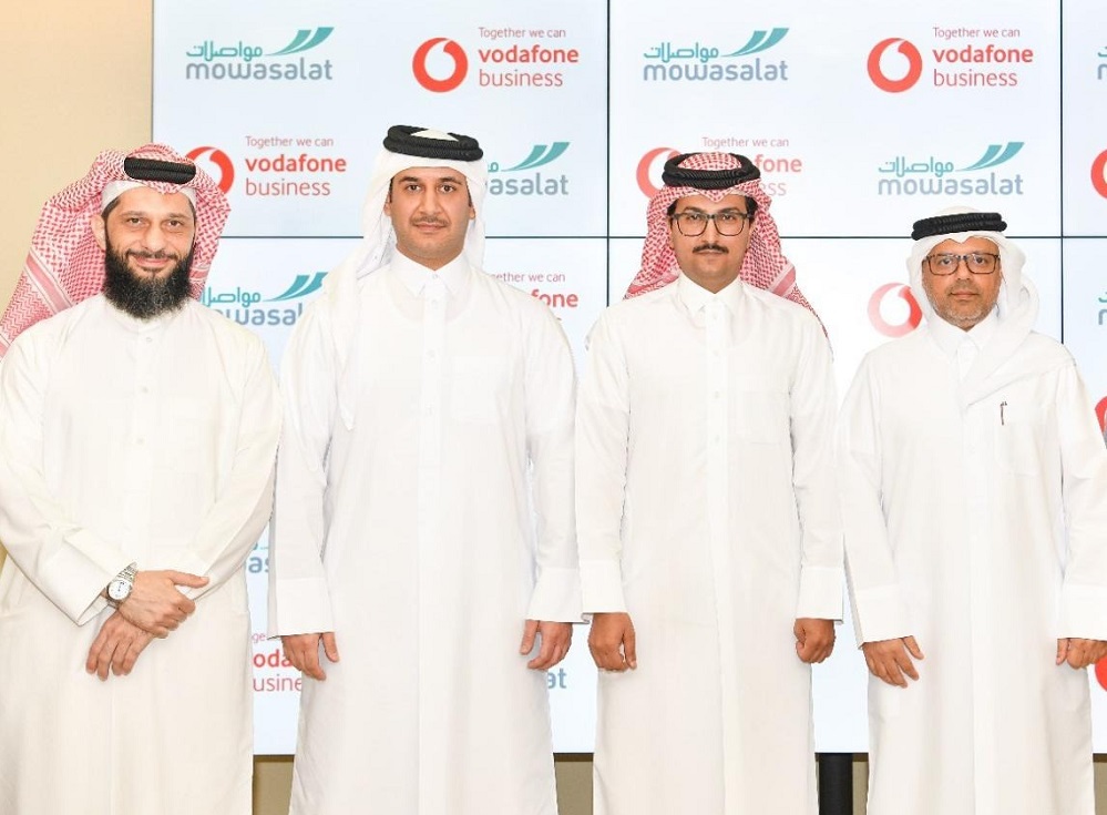 Vodafone Qatar and  Mowasalat officials exchange the agreement at the launch.