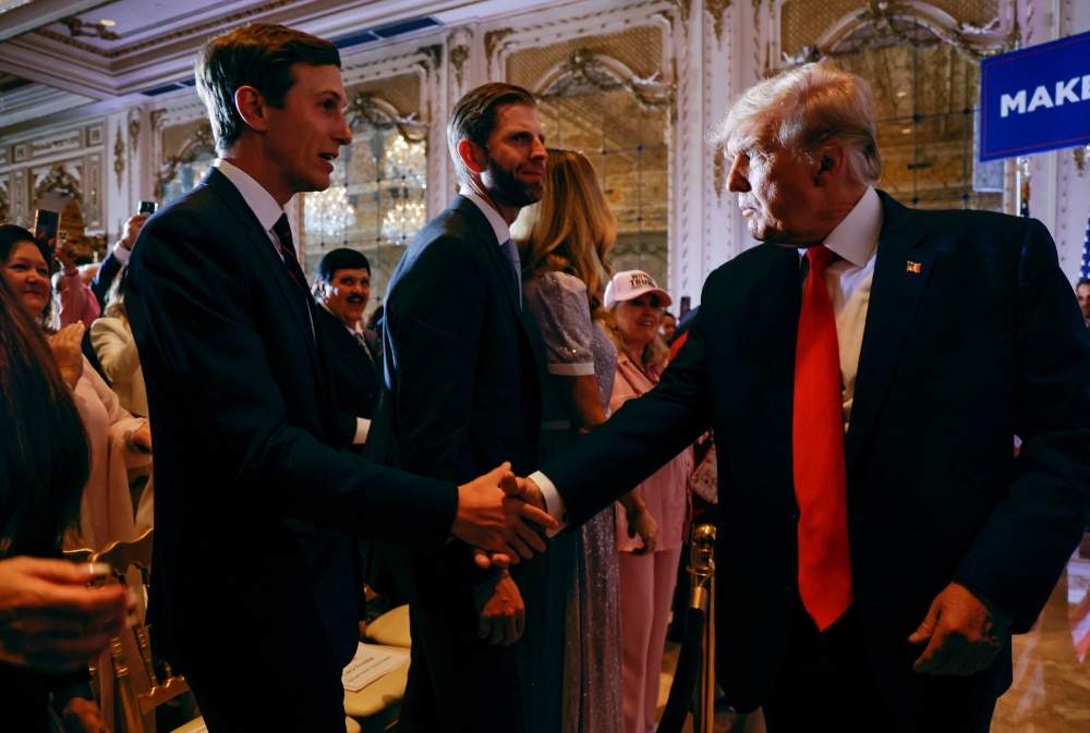 Former US President Donald Trump shakes hands with his son-in-law Jared Kushner in front of his son Eric after Trump announced that he will once again run for US president in the 2024 US presidential election during an event at his Mar-a-Lago estate in Palm Beach, Florida, US November 15, 2022. REUTERS/Jonathan Ernst