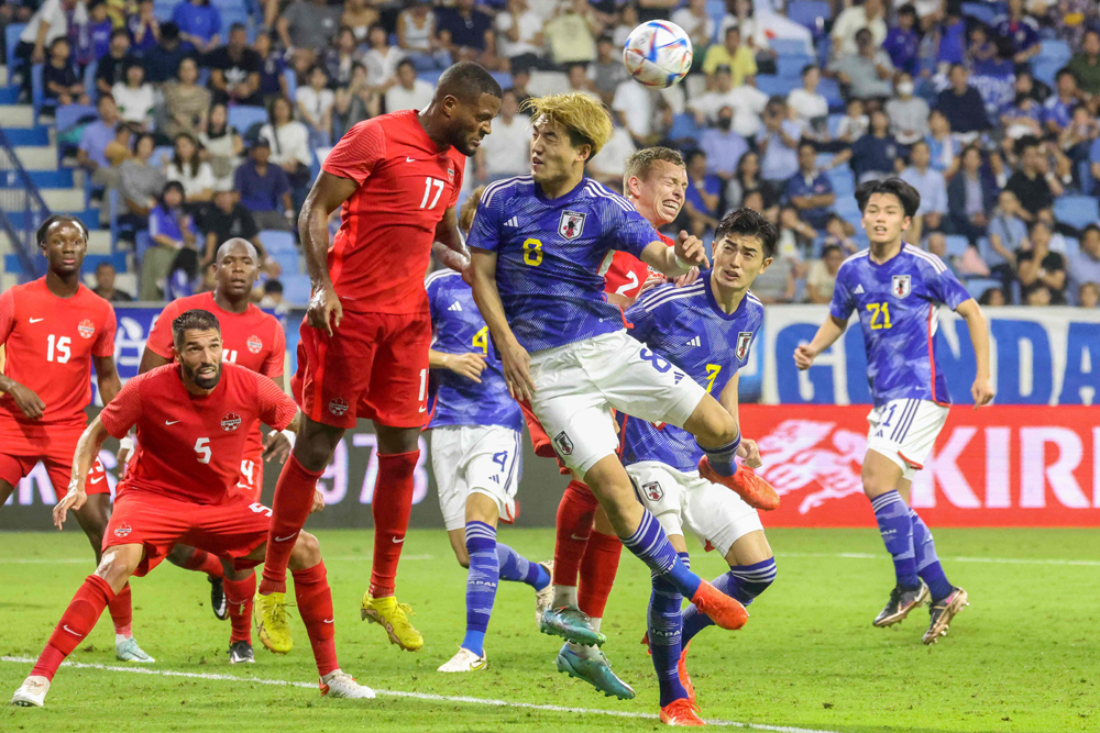 Canada's forward Cyle Larin and Japan's forward Ritsu Doan vie for a header during a friendly football match between Canada and Japan at Al Maktoum Stadium in Dubai, yesterday. Canada won 2-1. AFP