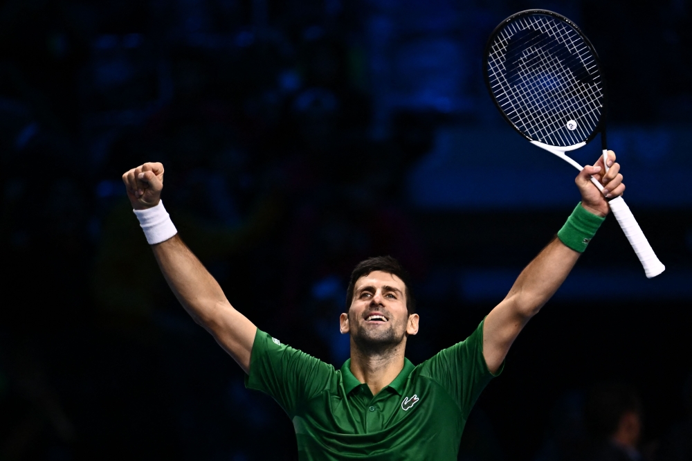 Serbia's Novak Djokovic celebrates after winning his round-robin match against Russia's Daniil Medvedev on November 18, 2022 at the ATP Finals tennis tournament in Turin. (AFP/Marco  Bertorello)