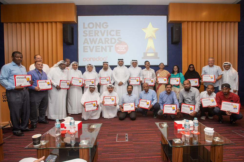 Ooredoo employees with other officials at the award ceremony.