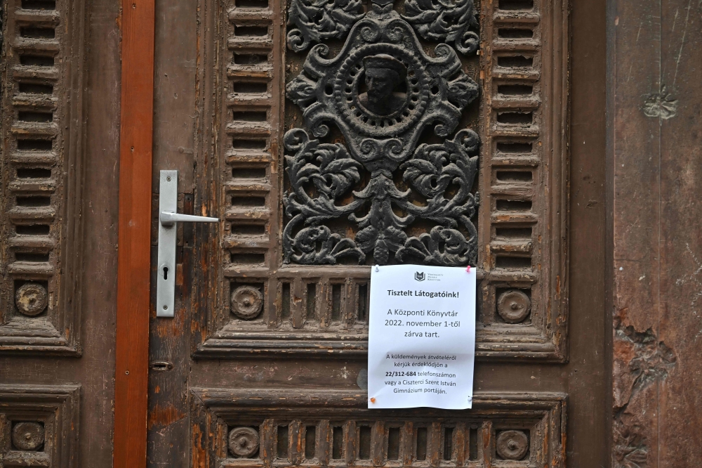 An information paper reading 'The central library is closed from November 1' hangs on the main entrance of the library in Szekesfehervar, Hungary, on November 9, 2022. Photo by Attila Kisbenedek / AFP