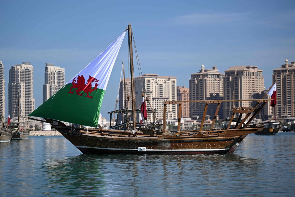A traditional Qatari Dhow boat bearing Wales' sail is pictured in Doha on November 29, 2022, during the Qatar 2022 World Cup football tournament. (Photo by NATALIA KOLESNIKOVA / AFP)