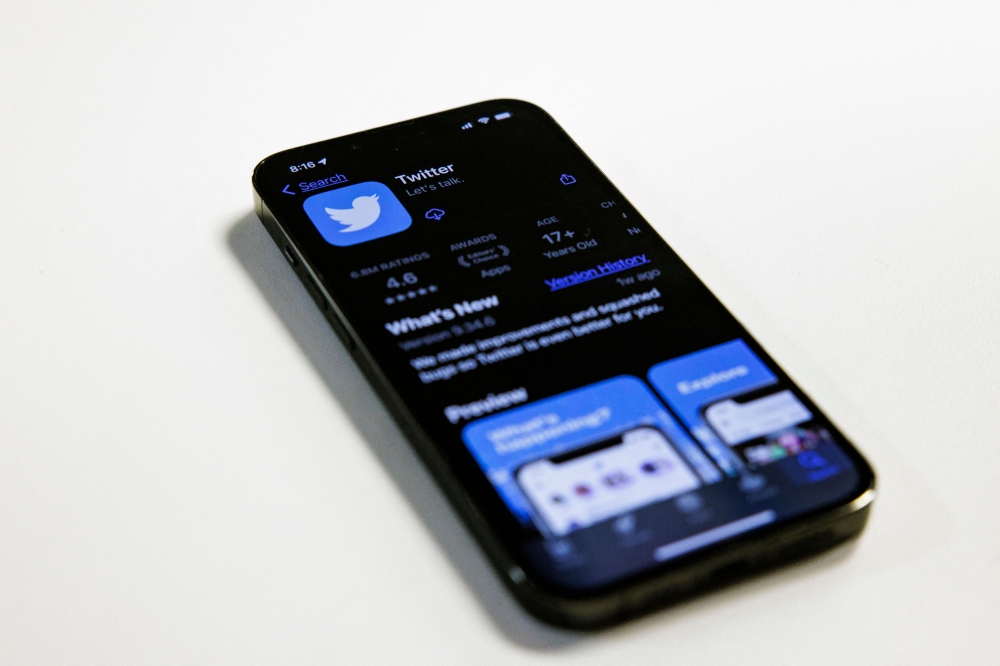 In this photo illustration, the Twitter app is seen in the Apple App Store on an Apple iPhone 13 Pro in Washington, DC, on November 28, 2022. (Photo by SAMUEL CORUM / AFP)
