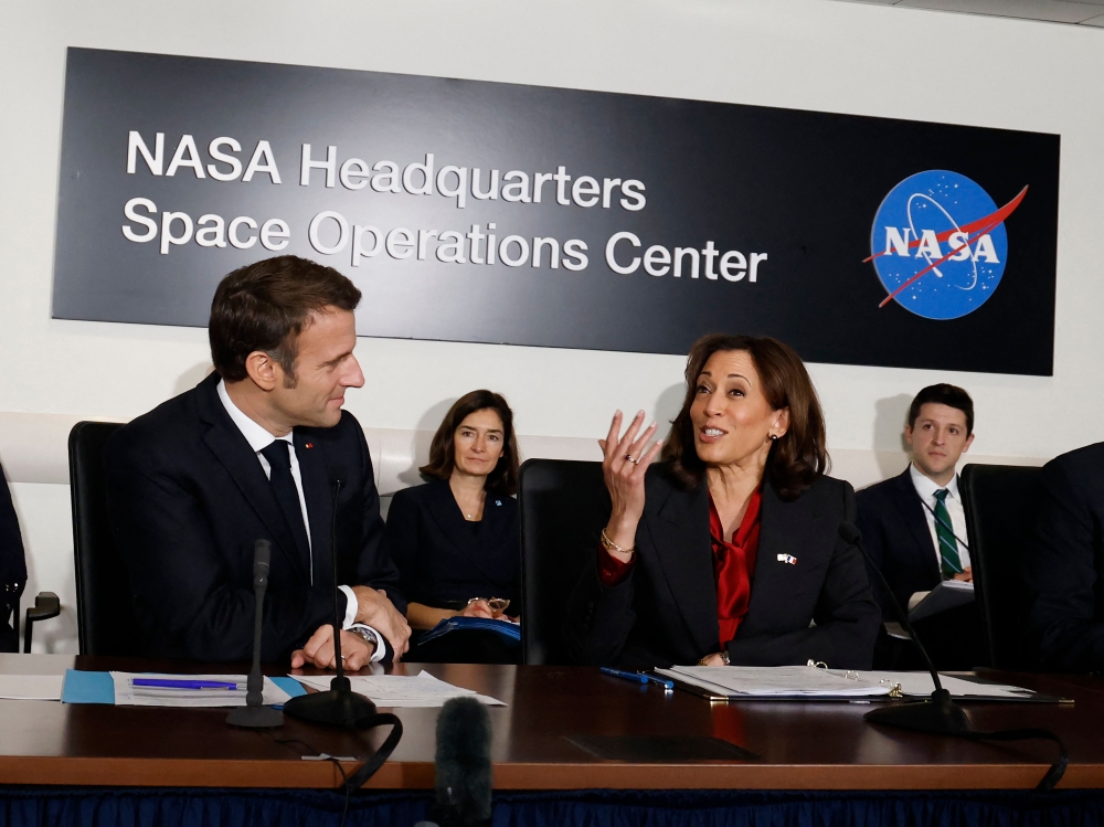 US Vice President Kamala Harris (right) and French President Emmanuel Macron attend a meeting on French-US cooperation in Space, at NASA headquarters in Washington, DC, on November 30, 2022. (Photo by Ludovic MARIN / AFP)