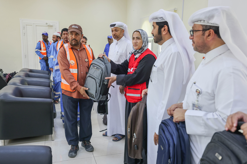 Officials distributing hygiene kits to workers.