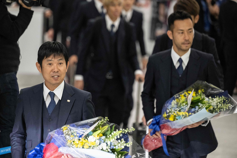 Japan’s head coach Hajime Moriyasu (left) and player Maya Yoshida arrive at Narita Airport in Narita, on Wednesday. AFP