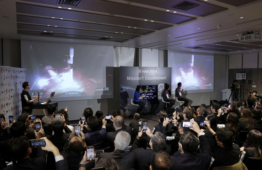 Officials of ispace Inc's HAKUTO-R mission look at live broadcasting of the launch of a SpaceX Falcon 9 rocket for ispace at Cape Canaveral Space Force Station, in Tokyo, Japan December 11, 2022. Kyodo via Reuters