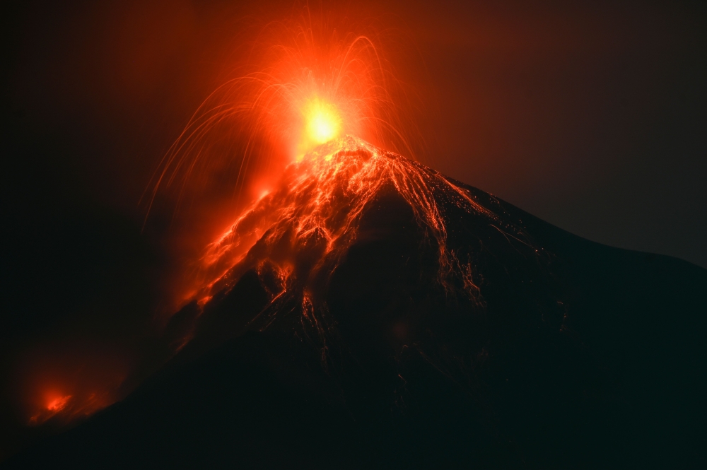 Fuego volcano, as seen from Alotenango, a municipality in Sacatepequez department 65 kilometres southwest of Guatemala City, erupts on December 11, 2022. (Photo by Johan ORDONEZ / AFP)