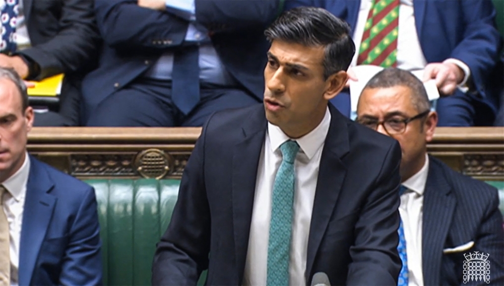 A video grab from footage broadcast by the UK Parliament's Parliamentary Recording Unit (PRU) shows Britain's Prime Minister Rishi Sunak addressing the MPs on illegal immigration at the House of Commons, in London, on December 13, 2022. (Photo by PRU / AFP) 