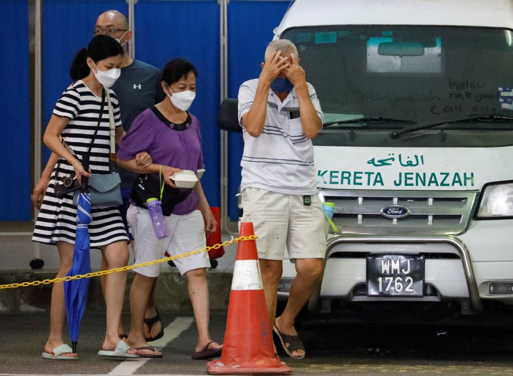 Family members of a Batang Kali, landslide victim, leave Sungai Buloh Hospital's mortuary in Sungai Buloh, Selangor, Malaysia, December 17, 2022. Reuters/Hasnoor Hussain