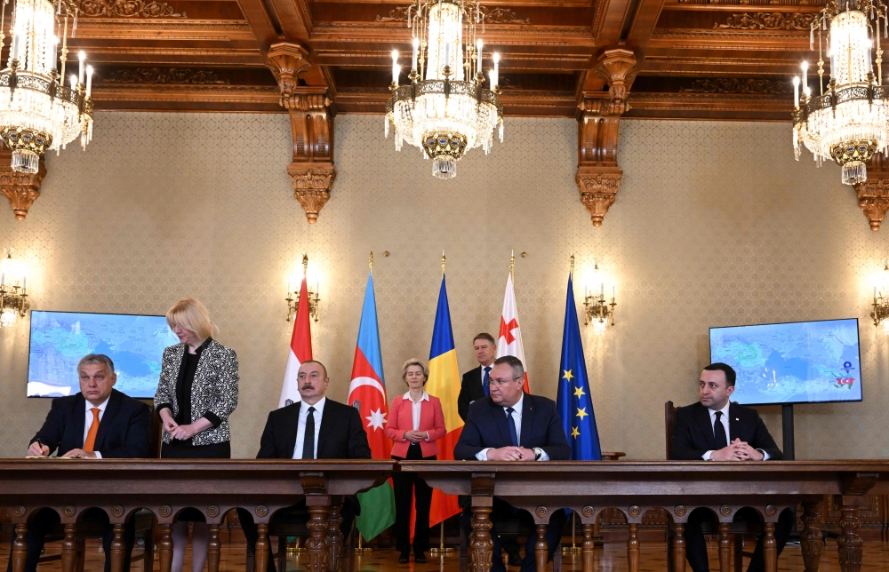 (From left) Hungary's Prime Minister Viktor Orban, Azerbaijan's President Ilham Aliyev, Romanian Prime Minister Nicolae Ciuca and Georgian Prime Minister Irakli Garibashvili sign an Agreement on Strategic Partnership in the Field of Green Energy Development and Transmission between the governments, while European Commission President Ursula von der Leyen and Romanian President Klaus Iohannis are seen in the background, at the presidential Cotroceni Palace in Bucharest on December 17, 2022. (Photo by Daniel MIHAILESCU / AFP)