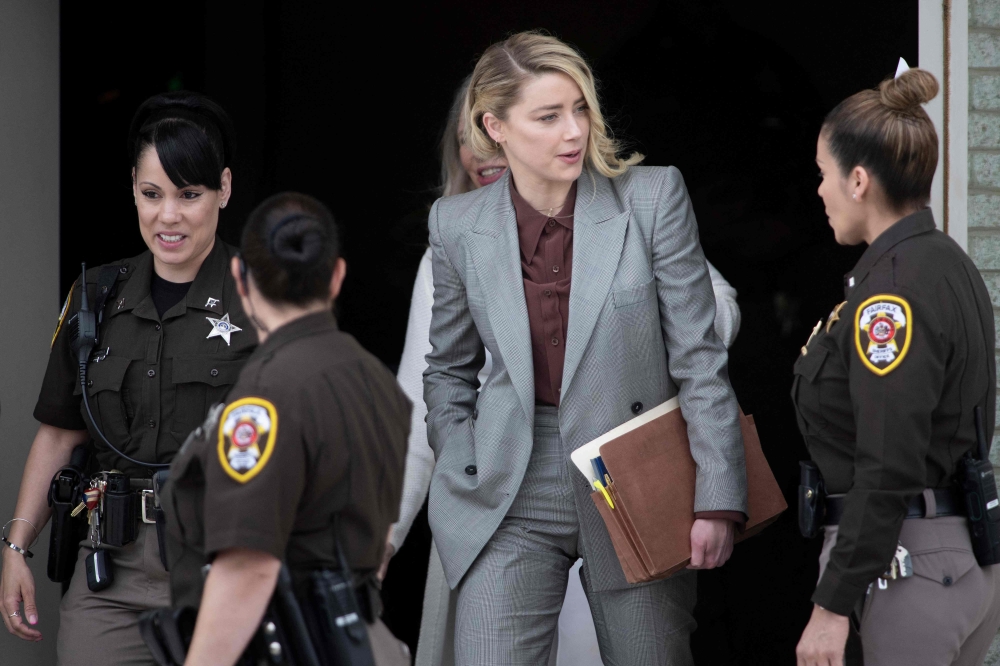 In this file photo taken on May 26, 2022 Actor Amber Heard leaves for the day during the Depp vs Heard deformation trial at Fairfax County Court in Fairfax, Virginia.  (Photo by Brendan Smialowski / AFP)
