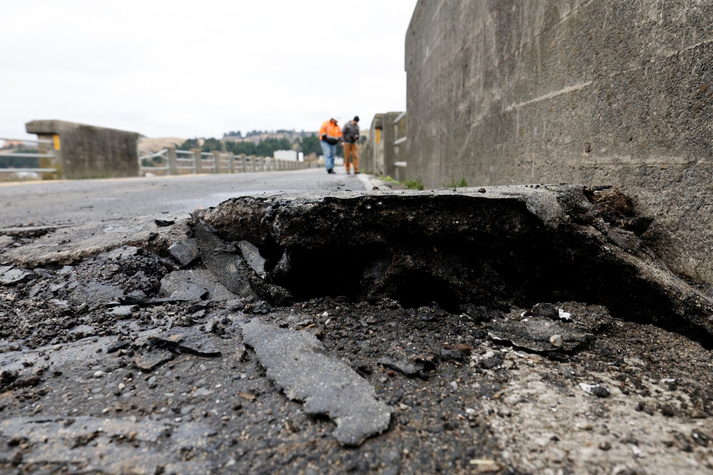 Large crack in bridge surface is seen after a strong 6.4-magnitude earthquake struck off the coast of northern California, in Rio Dell, California, U.S. December 20, 2022. REUTERS/Fred Greaves