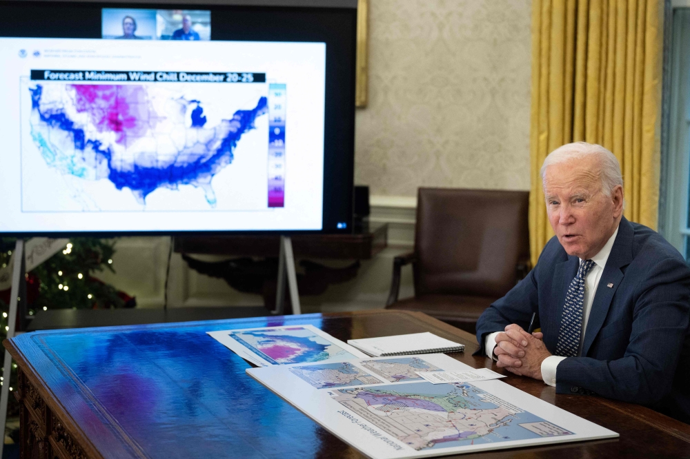 US President Joe Biden speaks during a briefing on the winter storm system traversing the US and the expected impacts, in the Oval Office of the White House in Washington, DC, on December 22, 2022. (Photo by Brendan Smialowski / AFP)