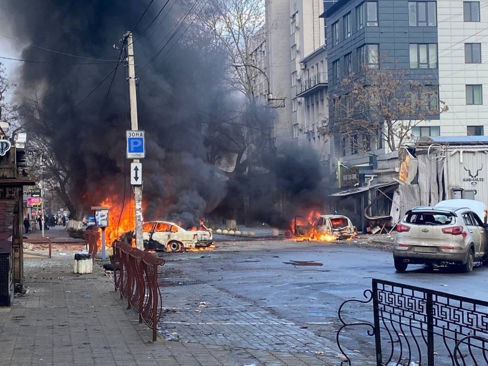 Cars burn on a street after a Russian military strike, amid Russia's attack of Ukraine, in Kherson, Ukraine December 24, 2022. 