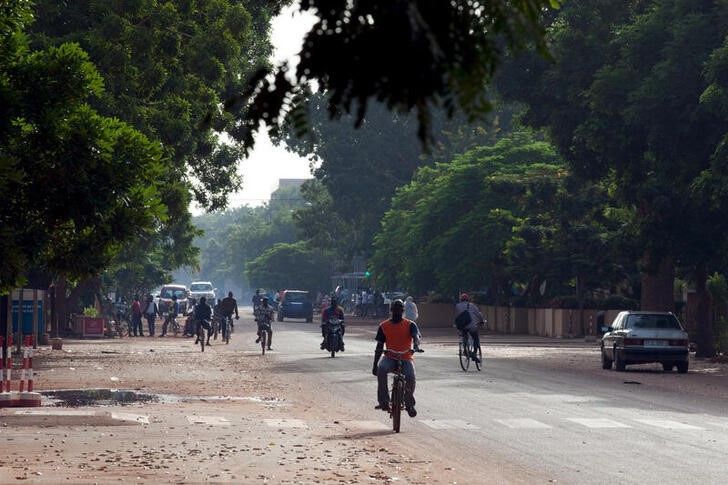 People ride bicycles and motorcycles on a street in Ouagadougou, Burkina Faso, on September 17, 2015. File Photo / Reuters




