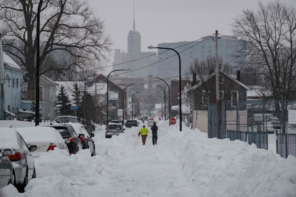 National Grid workers respond to a downed utility pole in Buffalo, New York, on December 27, 2022. Photo by Joed Viera / AFP