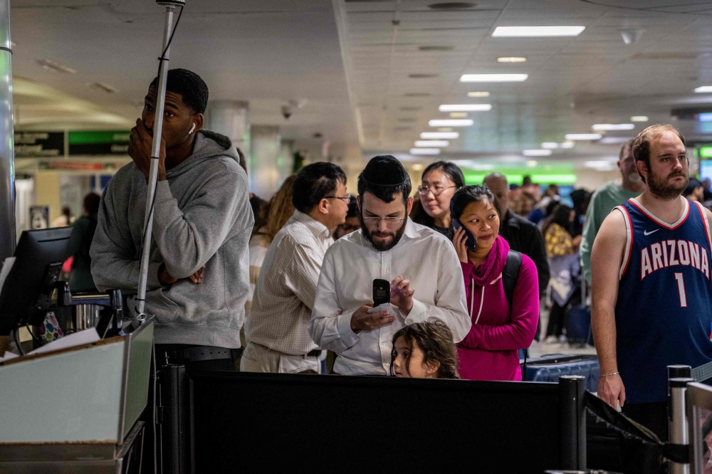 Travelers wait in line for assistance with lost luggage at the William P. Hobby Airport on December 28, 2022 in Houston, Texas. Brandon Bell/Getty Images/AFP