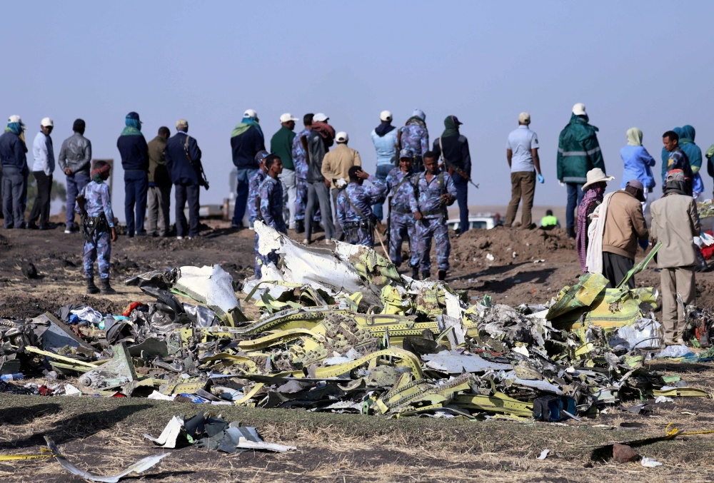 File Photo: Ethiopian Federal policemen stand at the scene of the Ethiopian Airlines Flight ET 302 plane crash, near the town of Bishoftu, southeast of Addis Ababa, Ethiopia, March 11, 2019. (REUTERS/Tiksa Negeri)
