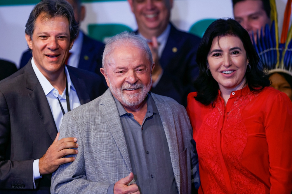 Brazilian Economy Minister nominee Fernando Haddad, Brazilian President-elect Luiz Inacio Lula da Silva and Planning Minister nominee Simone Tebet pose for picture during the presentation of the ministers nominated for his government at the transition government building in Brasilia, Brazil, on December 29, 2022. REUTERS/Adriano Machado