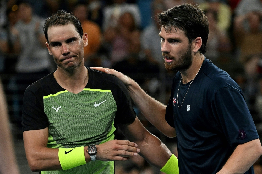 Britain's Cameron Norrie (R) shakes hands with Rafael Nadal of Spain after winning on December 31, 2022. (Photo by Saeed Khan / AFP) 