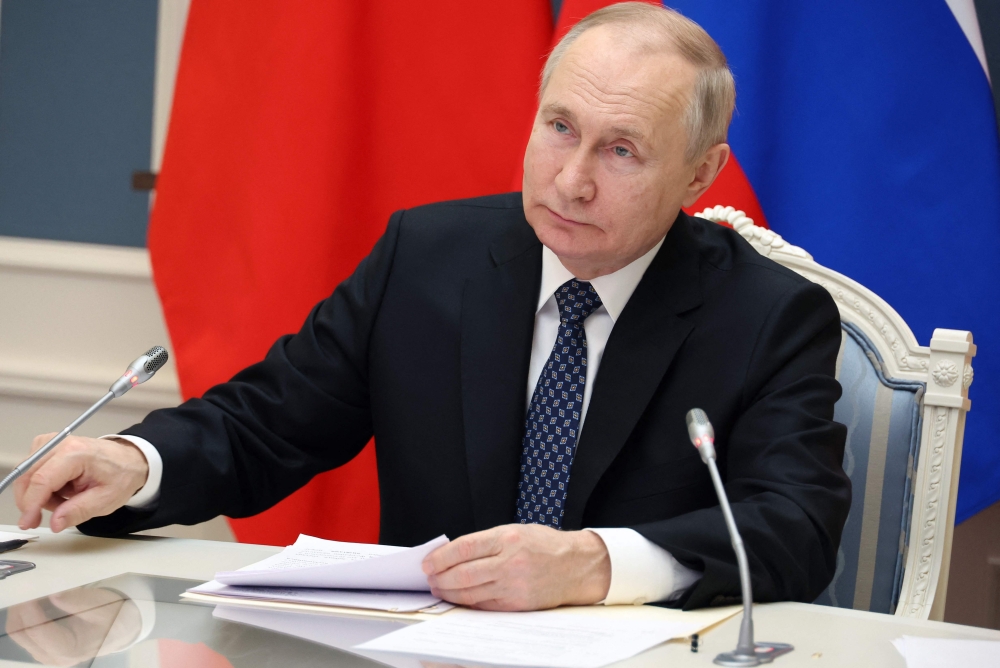 Russian President Vladimir Putin holds a meeting with Chinese President Xi Jinping via a video link at the Kremlin in Moscow on December 30, 2022. (Photo by Mikhail Klimentyev / SPUTNIK / AFP)