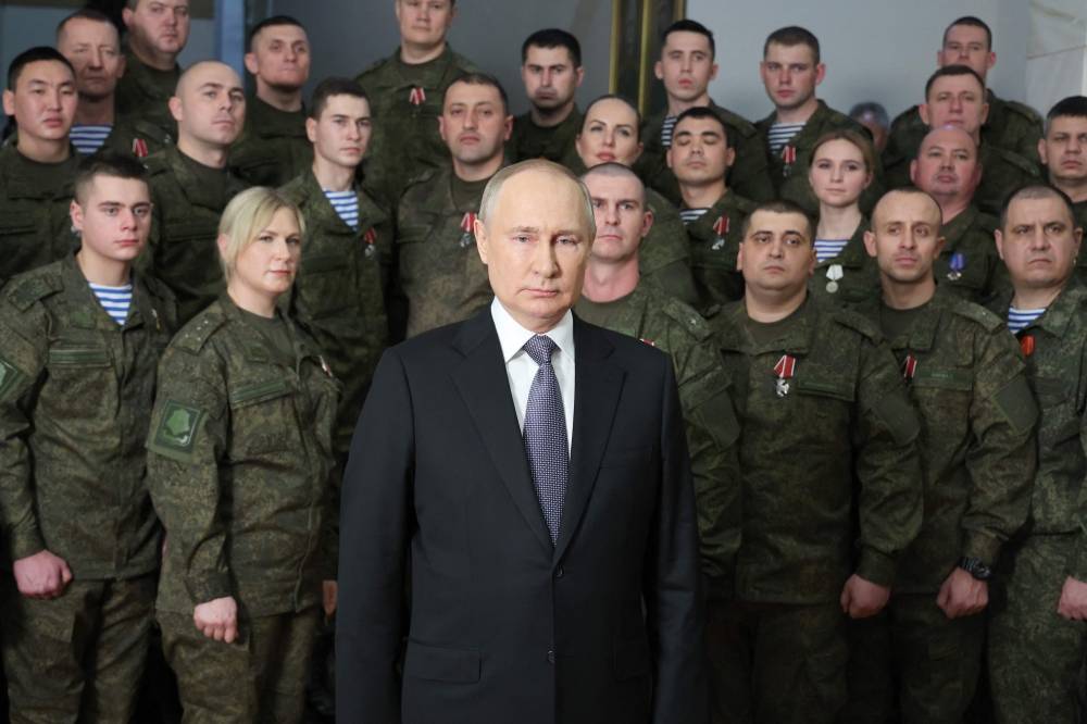 Russian President Vladimir Putin poses as he delivers a New Year's address to the nation at the headquarters of the Southern Military District in Rostov-on-Don on December 31, 2022. (Photo by Mikhail KLIMENTYEV / SPUTNIK / AFP)