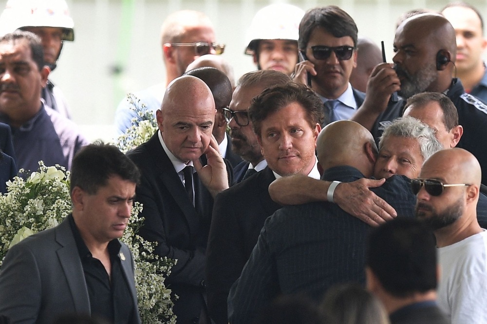 FIFA President Gianni Infantino (second left) and Conmebol President Alejandro Dominguez (third left) attends the wake of Brazilian football legend Pele at the Urbano Caldeira stadium in Santos, Sao Paulo, Brazil on January 2, 2023.  (Photo by CARL DE SOUZA / AFP)