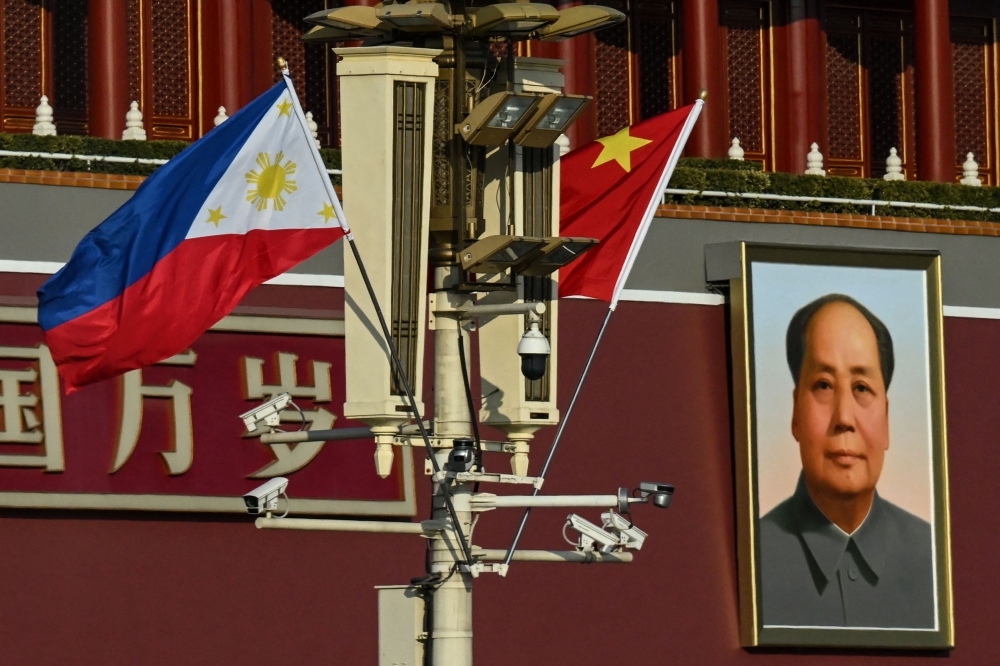 The national flags of the Philippines and China are seen together near the Tiananmen Gate as Philippine President Ferdinand Marcos Jr visits, in Beijing on January 3, 2023. (Photo by Noel Celis / AFP)