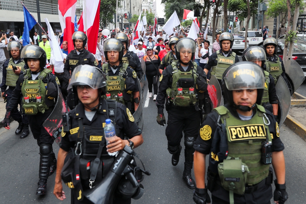 Police officers walk during a march asking for peace, after violent protests in the country, following the ousting and arrest of former President Pedro Castillo, in Lima, Peru January 3, 2023. (REUTERS/Sebastian Castaneda)